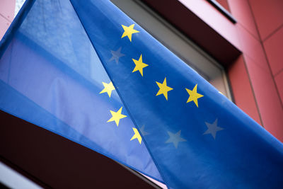 Low angle view of flag against blue sky