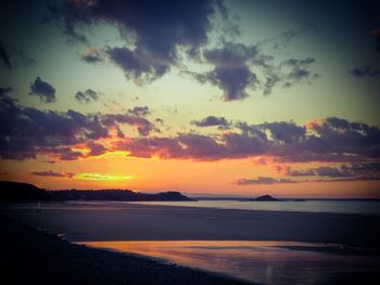 Scenic view of beach against sky during sunset