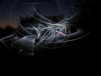 Digital composite image of light painting against black background