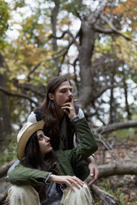 Happy young woman in forest