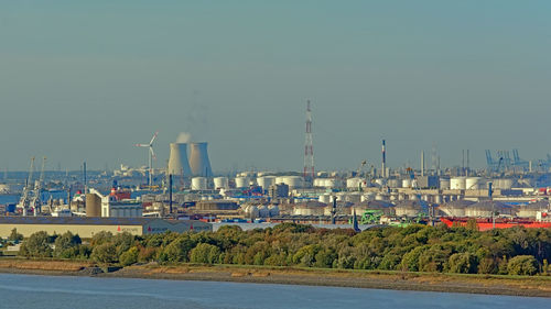 City by sea against clear sky