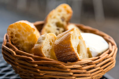 Close-up of bread in wicker basket on table