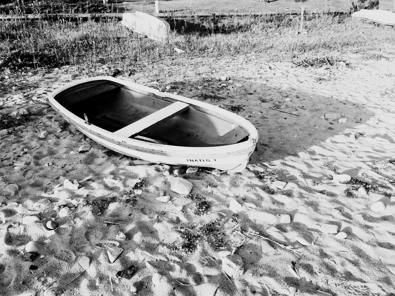 high angle view, sand, beach, water, grass, transportation, sunlight, outdoors, day, shore, boat, nature, tranquility, absence, field, abandoned, moored, lake, nautical vessel, lakeshore