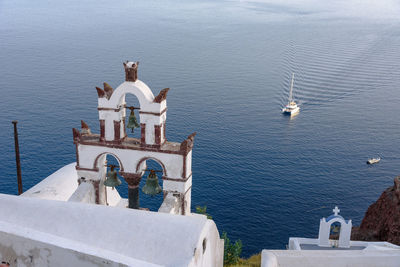 High angle view of statue by sea against sky