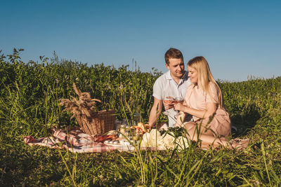 Couple kissing on field