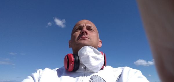 Low angle view of man against blue sky