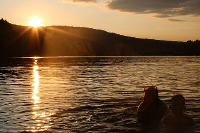 Scenic view of lake against sky during sunset