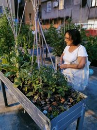 Woman standing by plants