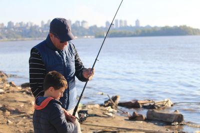 Rear view of men fishing in sea