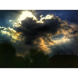 Low angle view of building against cloudy sky