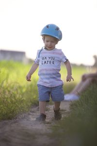 Full length of boy running on field