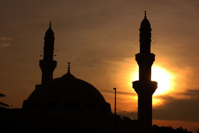 Silhouette of building against sky during sunset