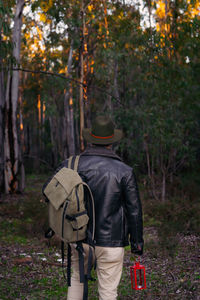 Rear view of man walking in forest