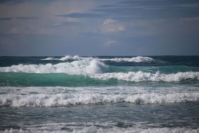 Scenic view of sea against cloudy sky