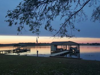 Pier on lake at sunset