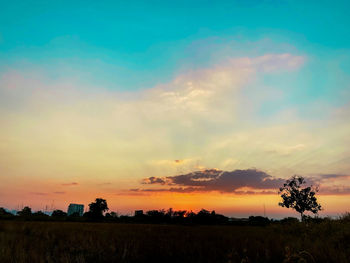 Scenic view of silhouette field against sky during sunset