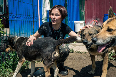 Side view of woman with dogs on field