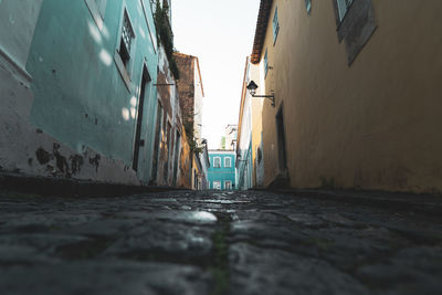 Surface level of narrow alley amidst buildings