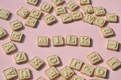 Close-up of alphabets on cookies over table