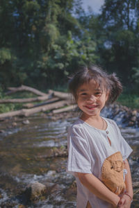 Portrait of smiling girl standing outdoors