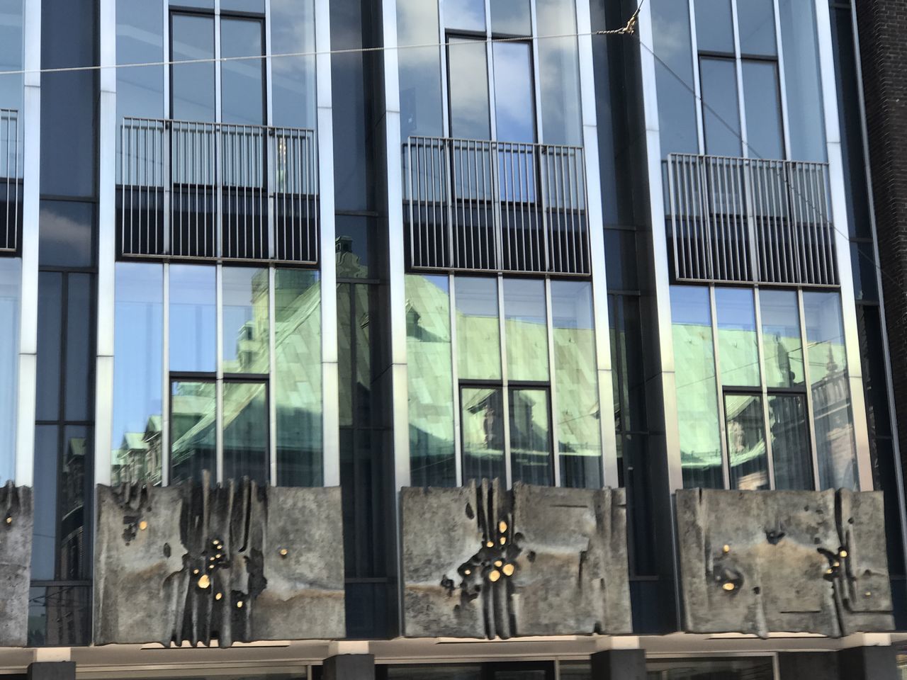 REFLECTION OF BUILDING ON GLASS WINDOWS