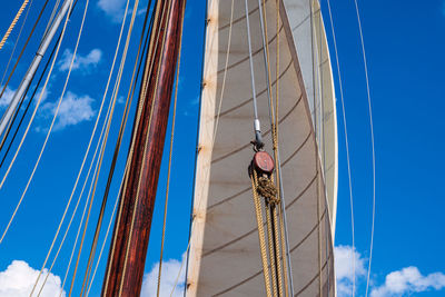 Low angle view of sailboat at construction site against sky