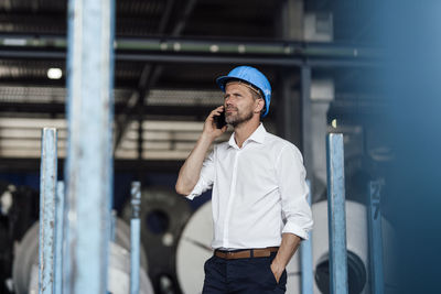 Full length of young man using mobile phone