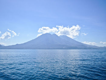 Scenic view of mountains against blue sky