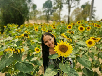 Portrait of young woman in sunflower field