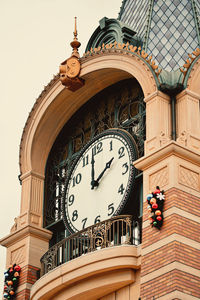 Low angle view of clock tower against building