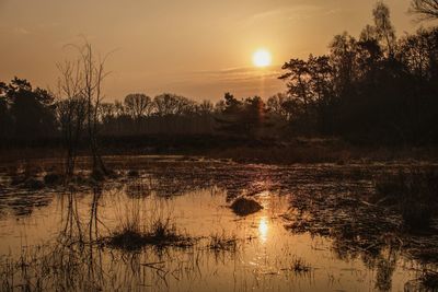 Scenic view of lake against sky during sunset