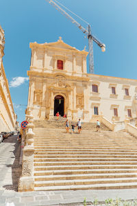 Low angle view of people walking on staircase