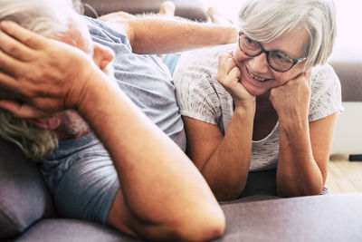 Midsection of couple sitting at home