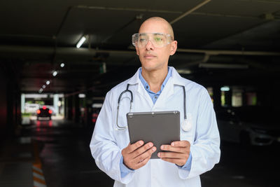 Portrait of young man using digital tablet