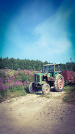 Abandoned tractor on field against sky