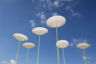 Low angle view of street light against blue sky