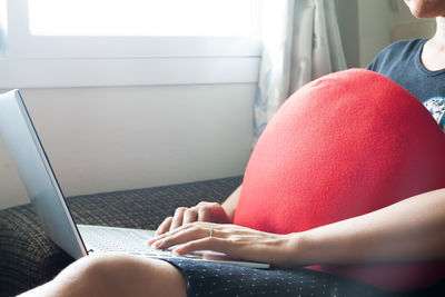 Midsection of woman using mobile phone