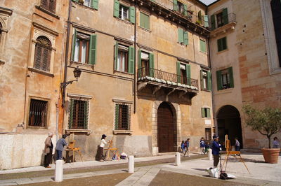 Painters on town square against building