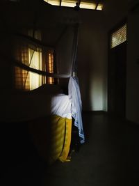 Man sitting in corridor of building