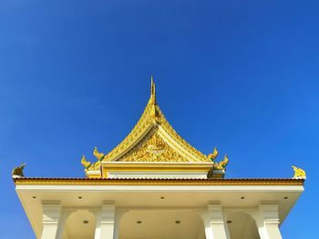 Low angle view of temple building against clear blue sky