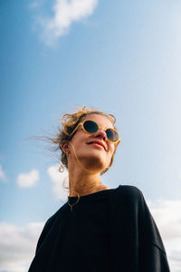 Low angle view of young man against sky