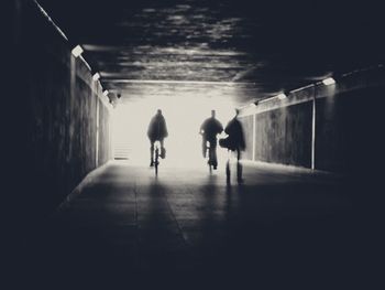 Rear view of silhouette people walking in subway