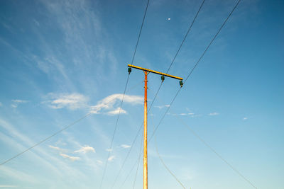 Low angle view of electric pole against sky