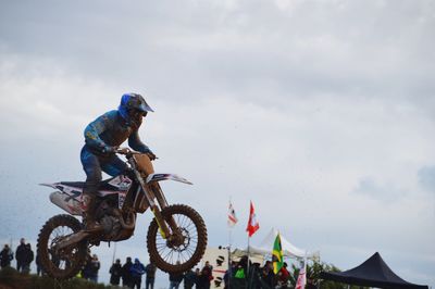 People riding motorcycle against sky