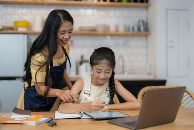 Young woman using laptop at home