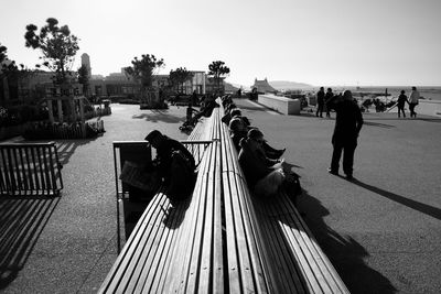 People sitting on park bench at mucem