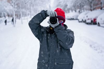 Man standing on snow covered field