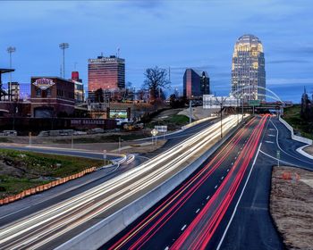 High angle view of light trails on highway in city