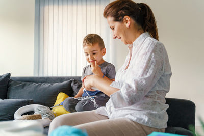 Mother and daughter sitting on floor