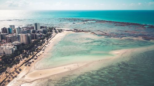 High angle view of sea and buildings against sky